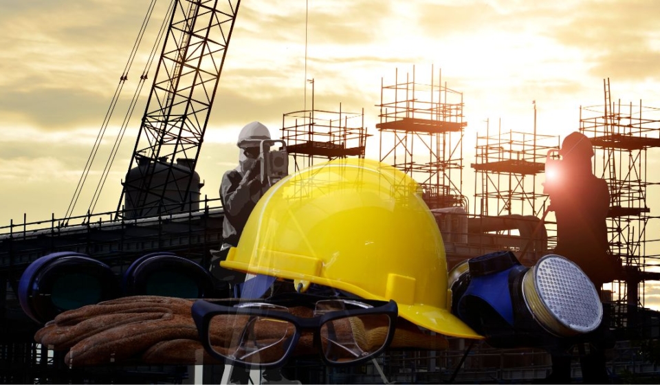 A construction worker wearing safety equipment for construction sites, including a helmet and goggles